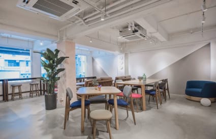 Bright, modern coworking space in Wan Chai with versatile seating and natural lighting.