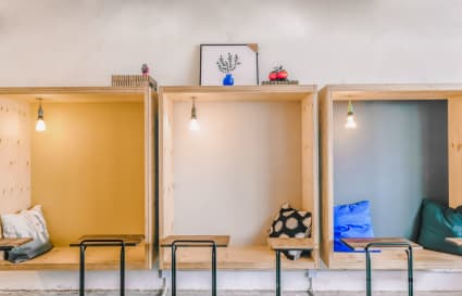 Cozy alcove seating with warm lighting and modern decor on Shantung Street. Ideal for productivity.