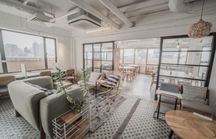 Stylish coworking space with open seating, natural light, and modern decor on Shantung Street.