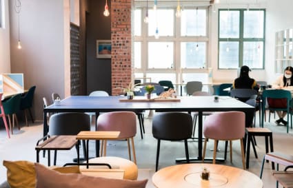 Stylish coworking space with modern seating, natural light, and vibrant decor in Kowloon.