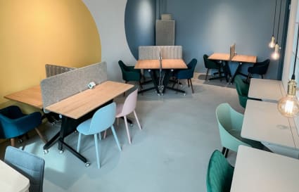 Bright, modern coworking space with cozy seating and stylish dividers on How Ming Street.