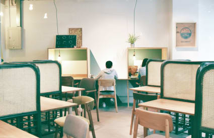 Bright coworking space with cozy booths and communal tables, ideal for focused work.