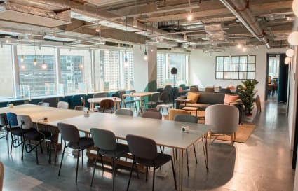 Bright coworking space with modern decor, ample seating, and natural light in Sha Tin.