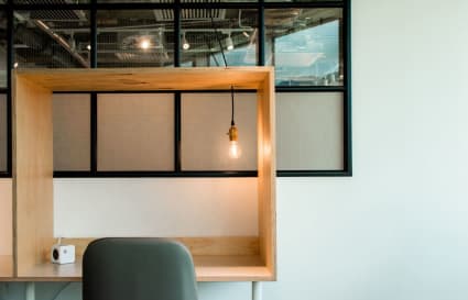 Modern coworking desk with warm lighting and a minimalist design, perfect for focused work.