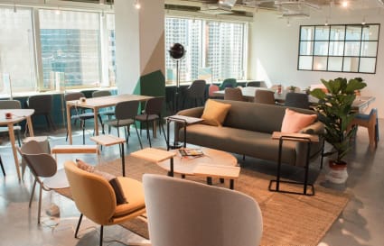 Bright coworking space with modern furniture, ample natural light, and open seating in Sha Tin.