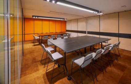 Modern coworking space with vibrant colors, flexible seating, and sleek lighting on King's Road.