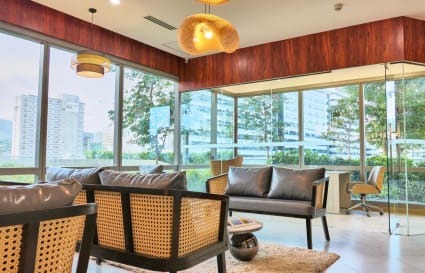 Bright coworking lounge with modern seating, natural light, and city views in Cebu.