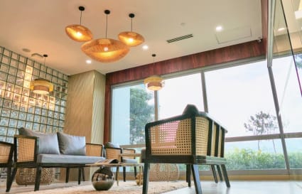 Chic coworking space with cozy seating, natural light, and stylish wicker lighting in Cebu.