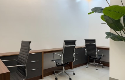 Sleek workspace with modern chairs, spacious desks, and abundant natural light. Ideal for productivity.