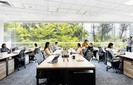 Bright coworking space with large windows and modern furnishings on Gateway Drive, Singapore.