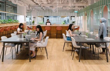 Bright coworking space with open seating, modern decor, and natural light. Perfect for collaboration.
