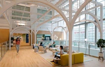 Bright and open coworking space with modern seating and natural light. Ideal for collaboration.