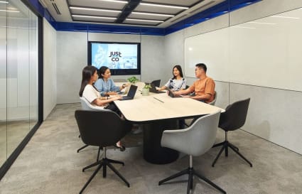 Modern meeting room with ergonomic chairs, sleek table, and high-tech AV setup in One-North Crescent.