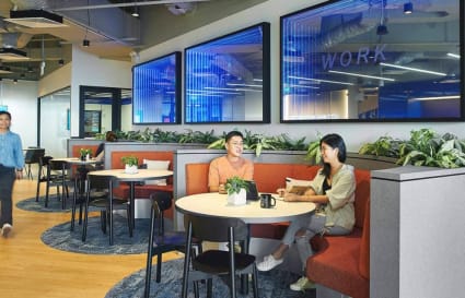 Vibrant coworking space with cozy seating, modern decor, and natural accents.