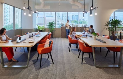 Bright, airy coworking space with modern furnishings and lush greenery in Tiong Bahru Road.