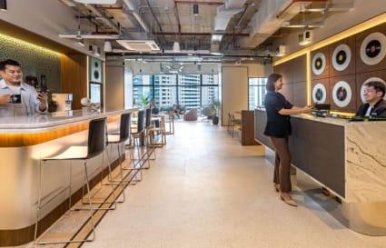 Modern coworking space with vibrant decor, open layout, and ample natural light. Perfect for collaboration.