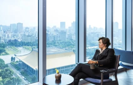 Bright coworking space with stunning city views, modern seating, and natural light.