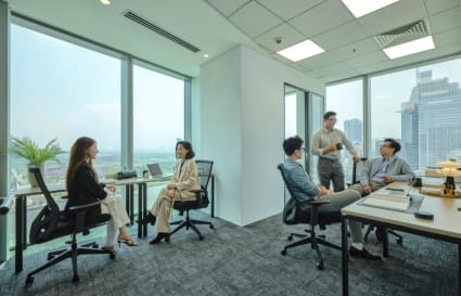 Bright coworking space in Saigon with skyline views, modern furniture, and collaborative areas.