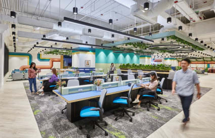 Vibrant coworking space with modern design, ample seating, and greenery accents. Ideal for creativity.