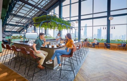 Spacious coworking area with large windows, modern seating, and a vibrant ambiance. Perfect for collaboration.