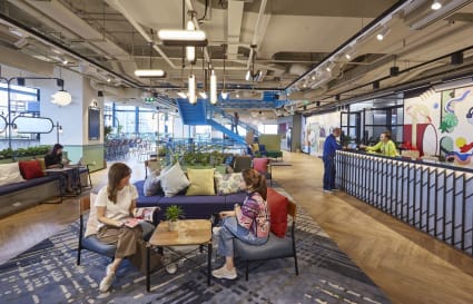 Vibrant coworking space with modern seating, bright decor, and ample natural light on Thanon Rama IV.