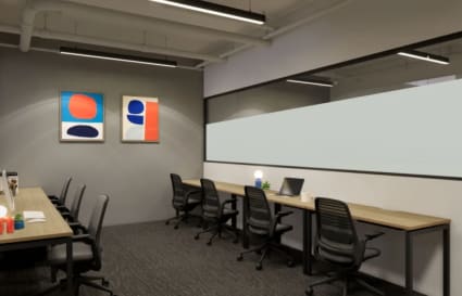 Modern coworking office with ample desks, ergonomic chairs, and contemporary artwork for inspiration.
