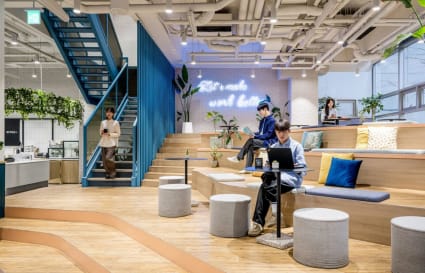 Stylish coworking space with tiered seating, vibrant decor, and a collaborative atmosphere.