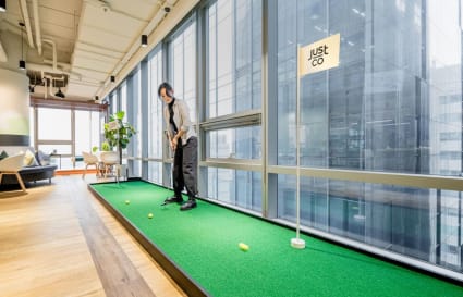 Modern coworking space in Gangnam with a mini-golf area and bright, airy interiors.