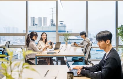 Bright, collaborative coworking space in Gangnam with city views and modern furnishings.
