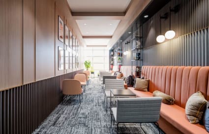 Modern coworking lounge with plush seating and abundant natural light. Ideal for collaboration.