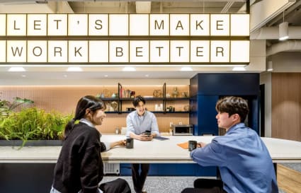 Modern coworking lounge with collaborative seating, greenery, and motivational decor in Jongno District.