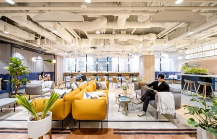Stylish coworking space with vibrant seating, natural light, and a welcoming atmosphere in Jongno District.
