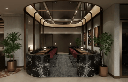 Elegant coworking area with sleek marble finishes, warm lighting, and greenery. Ideal for collaboration.