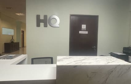 Welcoming reception area with modern marble desk in a Montevideo coworking space.