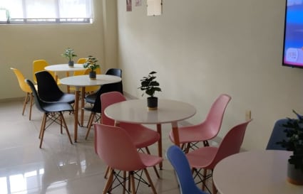 Vibrant coworking space with modern seating and ample natural light. Perfect for collaboration.