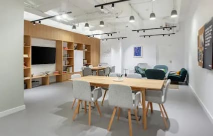 Modern coworking space with open seating, cozy lounge, and stylish lighting in Causeway Bay.