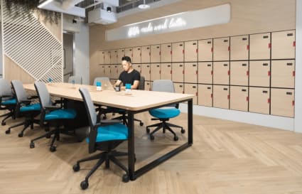 Modern coworking space with ample seating, natural light, and secure lockers. Ideal for productivity.