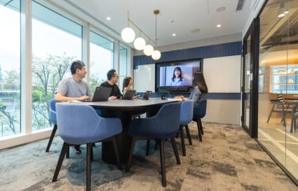 Modern meeting room in Taipei coworking space, featuring tech amenities and abundant natural light.