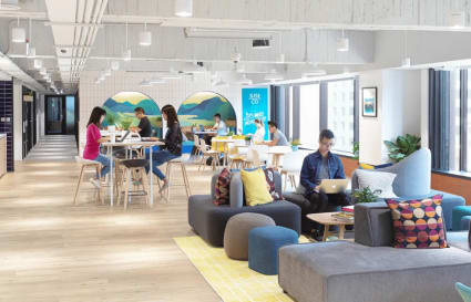 Bright, stylish coworking space featuring modern furniture and abundant natural light in Taipei.