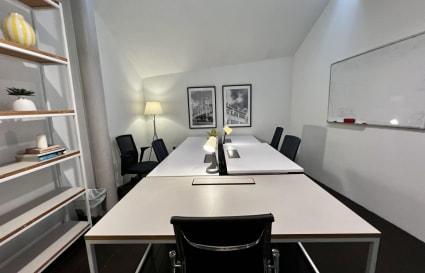 Modern coworking space with sleek desks, warm lighting, and a collaborative atmosphere.