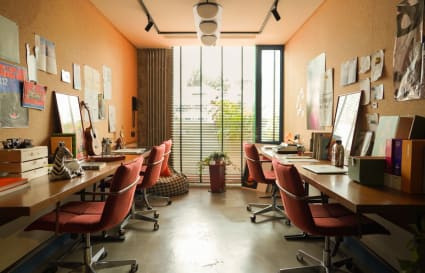 Bright, creative coworking space with ample natural light and collaborative seating.