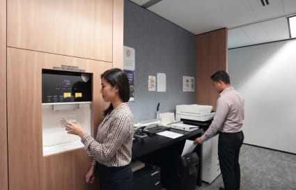 Modern coworking space with state-of-the-art printing station and sleek design features.