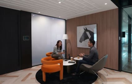 Modern coworking area with cozy seating and contemporary art, perfect for collaboration.