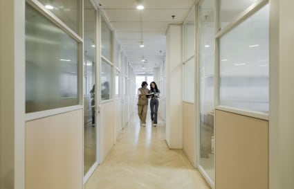 Modern coworking space with glass-panelled offices and bright, inviting hallways in Jalan Kiara.