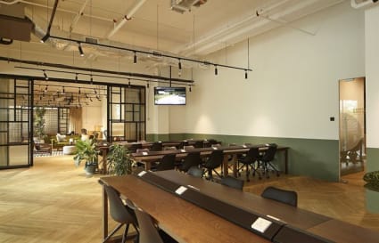Modern coworking space with open layout, ample seating, and natural lighting. Ideal for productivity.