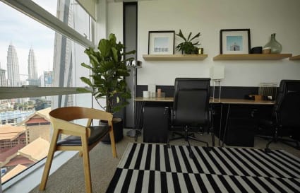 Stylish coworking space with city views, modern furnishings, and ample natural light.