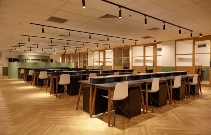 Modern coworking space with sleek desks, ample seating, and warm lighting in Jalan Kolam Air Lama.