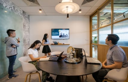 Modern coworking space with collaborative meeting area and multimedia setup in Kuala Lumpur Sentral.