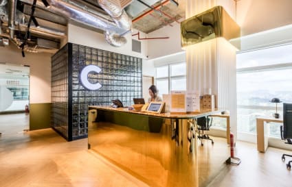 Modern coworking reception with chic design and ample natural light in Kuala Lumpur Sentral.