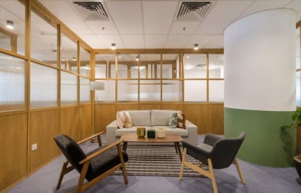 Chic coworking lounge with cozy seating, stylish decor, and ample natural light on Jalan Moulmein.